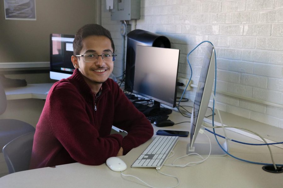During his Journalism class, Bangladeshi foreign exchange student Prottay Roy Chowdhury (11) grins at the camera in the North Computer lab.