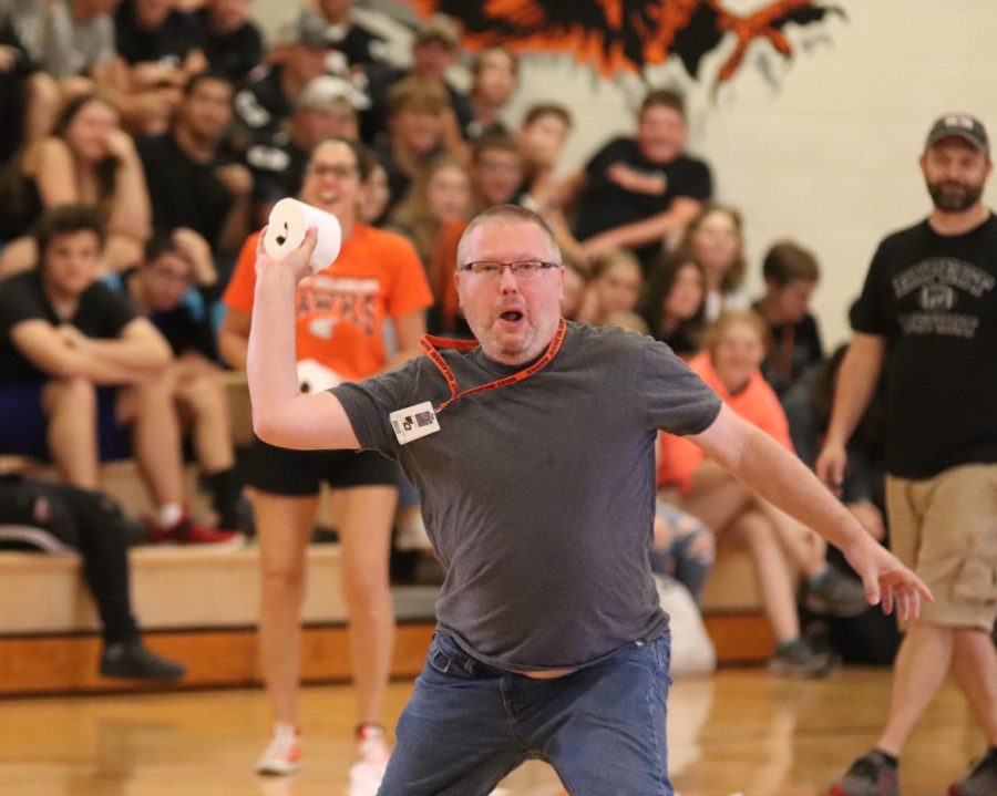 Technology specialist Gary Lubben prepares to launch a toilet paper roll in a game of TP Dodgeball during the Homecoming Olympics last fall.
