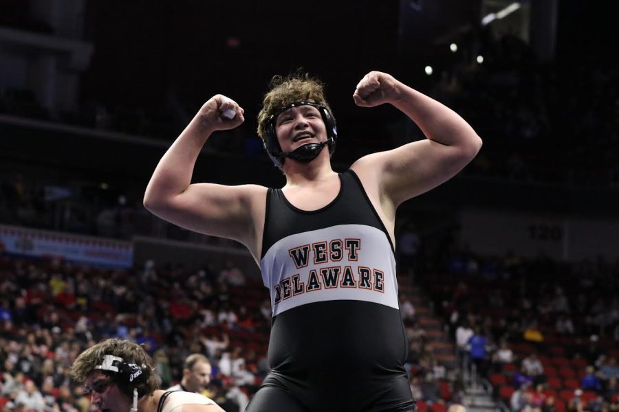 Cameron Guether (11) poses for the fans after his 7-4 decision over his second round opponent at the State Wrestling Tournament.