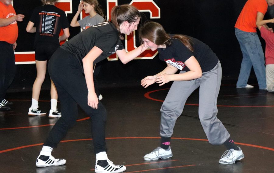 Eager to learn, freshmen Hannah Cantwell and Maleah Demmer learn the basics of wrestling in an open gym held Feb. 10 in the multipurpose room. 