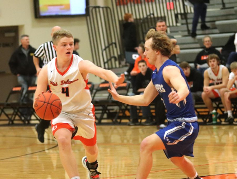 In the first half of the game, sophomore Conrad Smith dribbles the ball around Clear Creek Amana’s defense in Seedorff Gymnasium. The Hawks stole the victory, 52-44 in overtime.