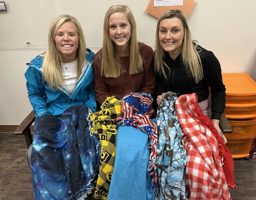 DelCo Best Students, Ella Koloc (12), Allie Demmer (11), and Keara Emerson (11) pose with five of their 20 blankets.