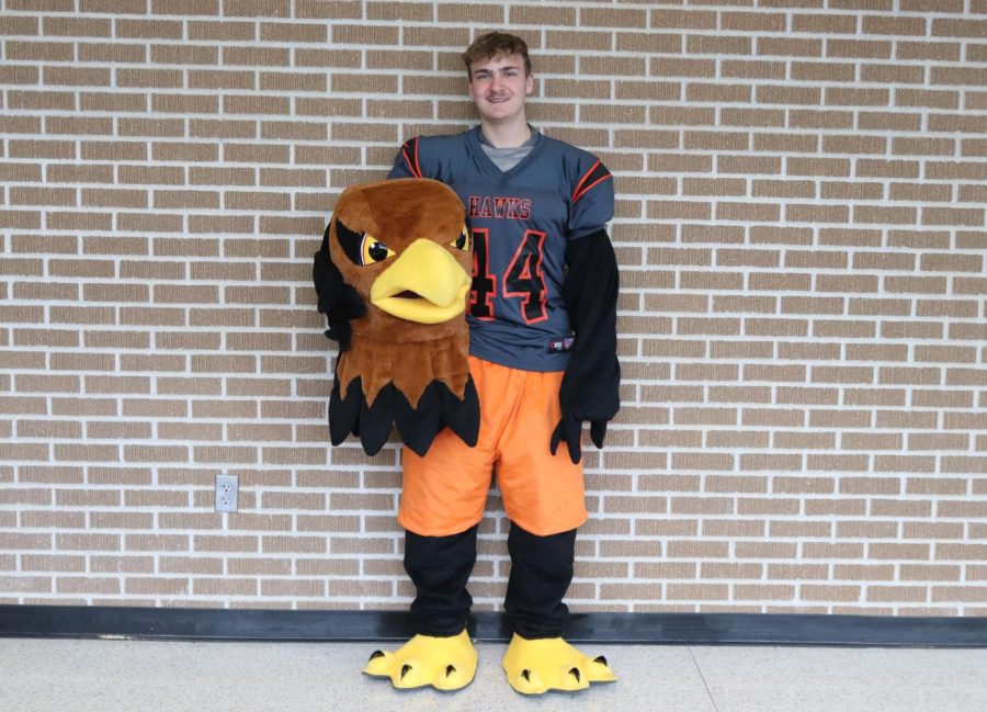 Junior Peyton Aldrich poses in the new Hank the Hawk mascot costume. 