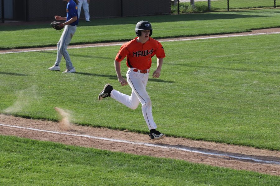Brody Kafer (10) strides out to first base. The Hawks finished the game with the score of 8-0 against Benton. 