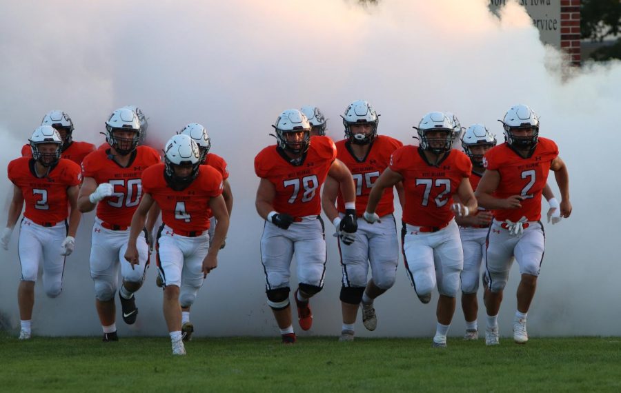 Prior to the season opening game vs Dubuque Wahlert, the seniors lead the charge through the smoke.