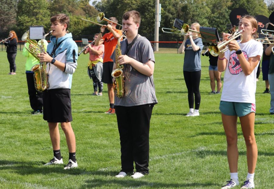 In the middle of the third hour, Zachary Kramer (11), Chase Hutchinson (9), and Anna O’ Rear (9) rehearse at the football field. The band students prepared for the football game’s halftime show.