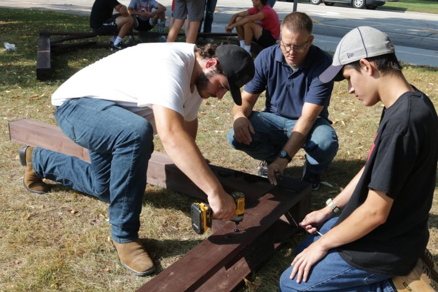 While placing the pieces together, Xander Zack (12), teacher Chad Sellers, and Hunter Drapeaux (12) work together to create the pavilion out in front of the middle school.