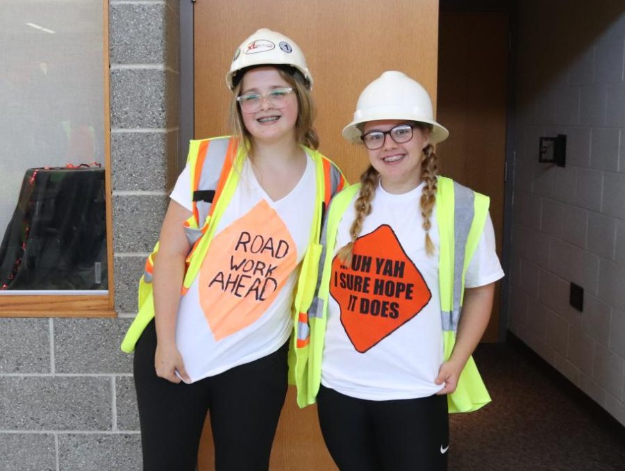 Posing for a picture, Madison Wieser (11) and Madelynn Zehr (11) show off their t-shirts. Many students dressed up for Thursdays Construction Day theme.