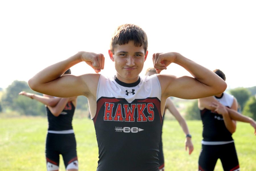 Ashton Fangman (10) flexes to get pumped up before the cross country meet. 