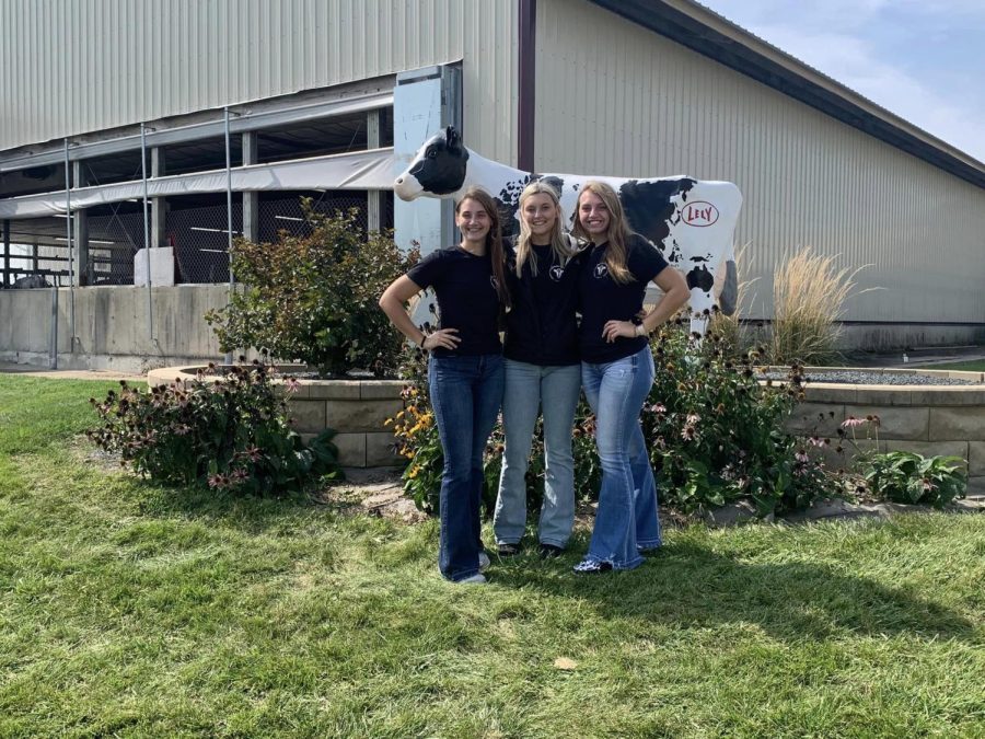 Maleah Demmer (10), Keara Emerson (12), and Sydney Demmer (12) pose in front of the Iowa Dairy Center after finishing their milk quality contest. 