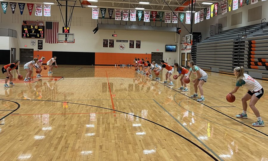 Warming up for their second day of practice, The West Delaware girls basketball team works on their ball handling skills. 

