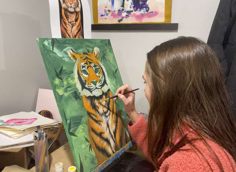 Focusing on her painting, Cantwell adds fine details.