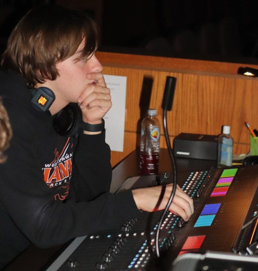 Quint makes adjustments to increase the sound quality during musical rehearsal. 