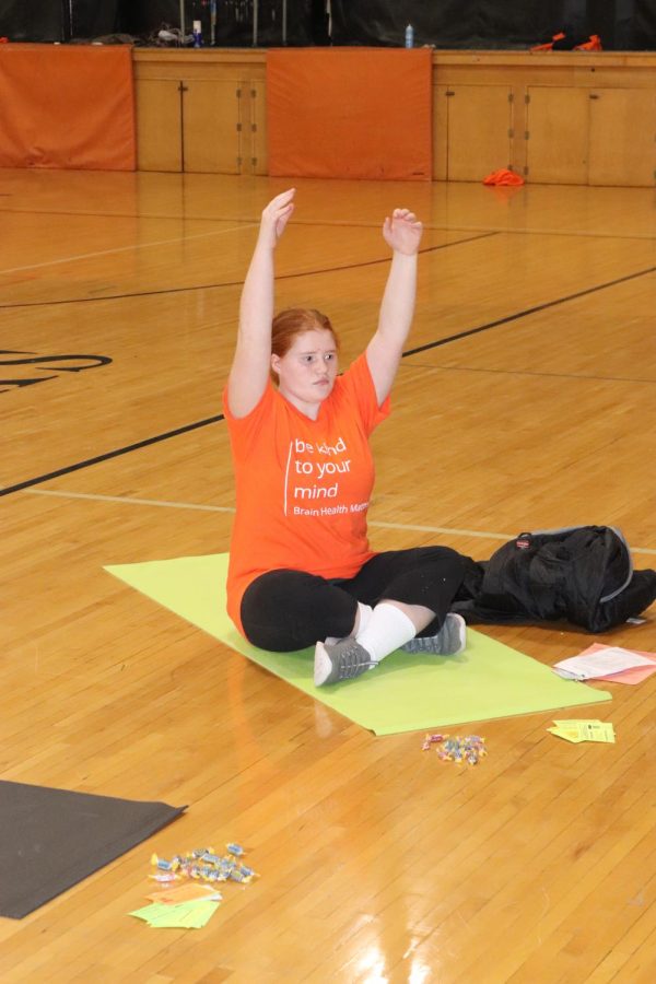 Freshman Mylee Hoffman stretches during Be Kind To Your Mind day in the upper gym.
