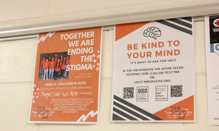 West Delaware puts up signs to promote the upcoming mental health event.