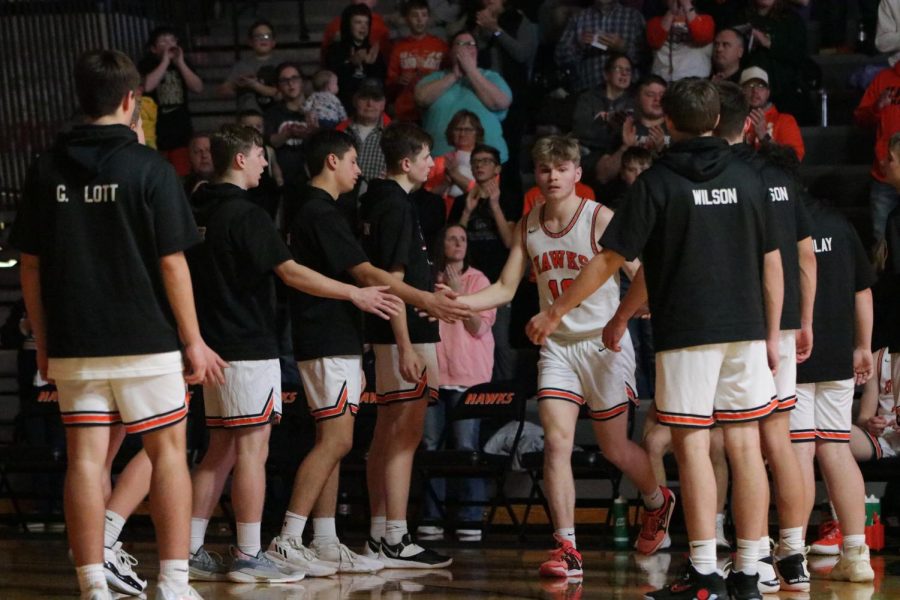 After being introduced as a starter, senior Hayden Lyness high fives his teammates