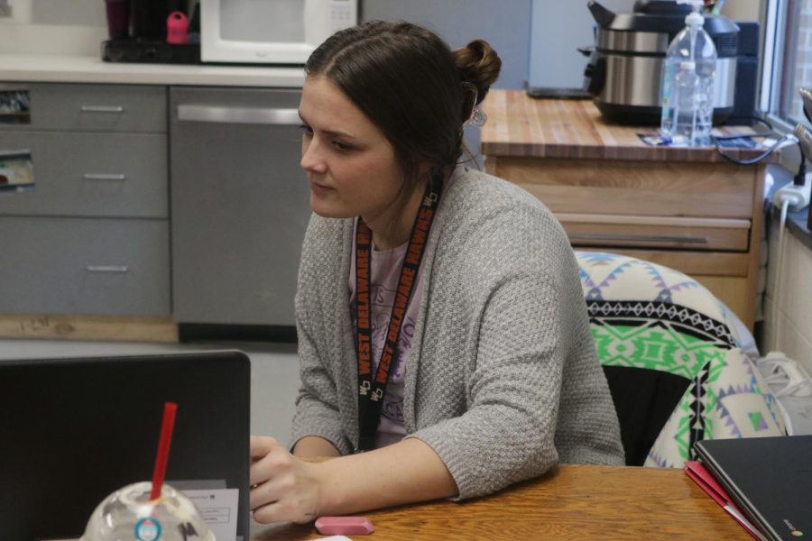Associate Brianna Schultz helps one of her students with their school work.