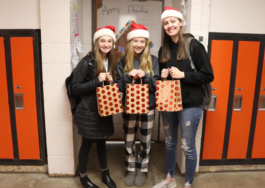 Before holiday break, FBLA members junior Ashleigh Hartman, freshman Isabelle Demmer, and senior Alison Deutmeyer deliver holiday cards to residents at the Good Neighbor Home. 