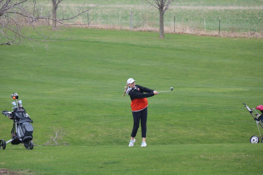 Susie Funke hits an iron, which moves her ball towards the green. 