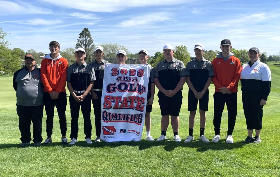 Golf team state qualifiers and alternates stand next to the state banner: Assistant Coach Harold Athas, Mason Roling, Griffin Lott, Aidan Zirtzman, Cameron Downs, Jack Buesing, Macoy Peyton, Colson Mersch, Keevan Hauschild, Coach Christi Imsland. 