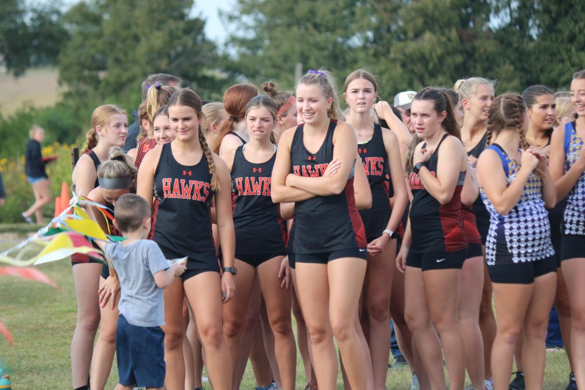 Prior to their race at Starmont, cross country girls listen to their coachs son Kallum Moser give an inspirational pep talk.