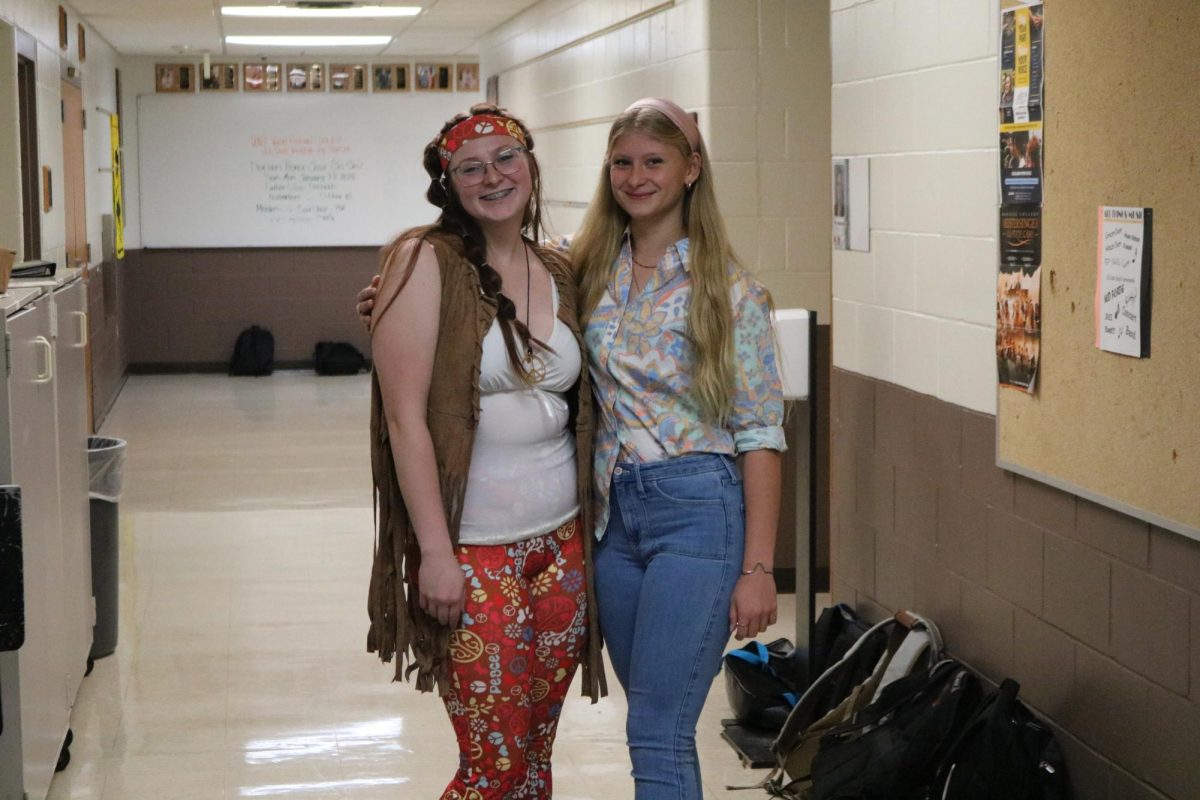 Showing their school spirit, Lilly Bunting (12) and Natalie Beilby (10) pose for the camera on Tuesday, Sept. 19. Students dressed up in Denim & Disco for Tuesdays theme.