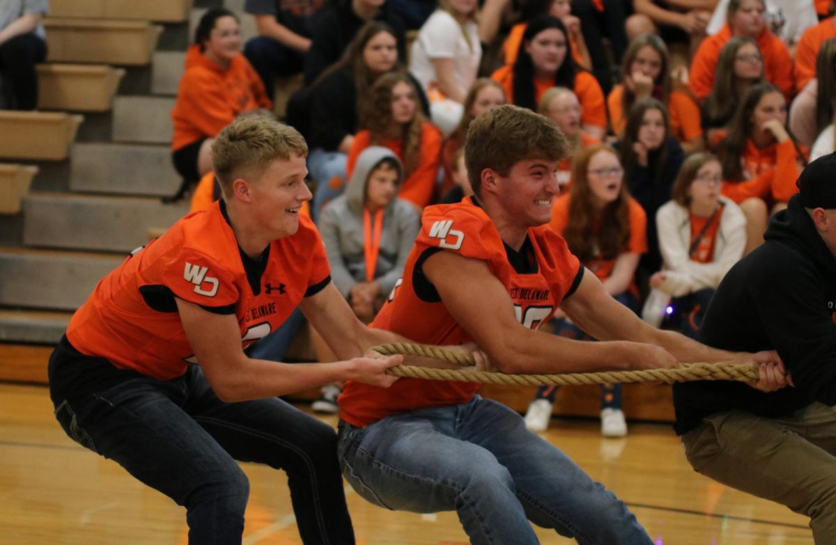 In the tug-of-war championship at the homecoming pep rally on Sept. 22, seniors Conrad Smith and Jack Smith anchor the senior team. 