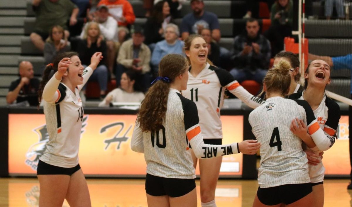 Achieving a win against Vinton-Shellsburg on Oct. 17, Kate Wenger (11), Natalie Mensen (10), Addison Huffman (11), Norah Peyton (10), Vedah Langel (10), and Kirstyn Kolbet (11) celebrate their final point of the game. The Hawks fought for their win in three sets (25-21, 25-21, 25-6). 