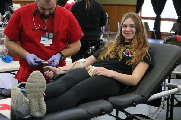 Junior Addison Huffman smiles for a photo while donating blood. This was Huffmans first time donating.