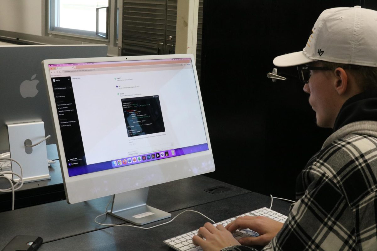 Keevan Hauschild (12) uses AI to create a sample of computer code. This highlights one of many uses for AI.