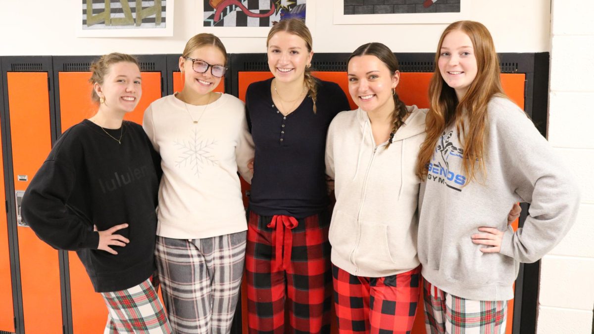 Sydney Shover (11), Maggie Millencamp (12), Josie McMahon (11), Kyndall Nelson (12), and Mia Hodson (12) show off their Christmas pajama pants during the Christmas dress up week. 