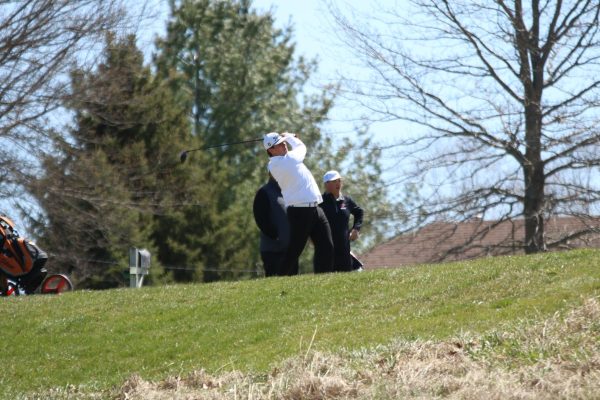 After hitting his drive, Griffin Lott (11) watches his ball, waiting for it to land. Lott is one of four three-year varsity golfers.