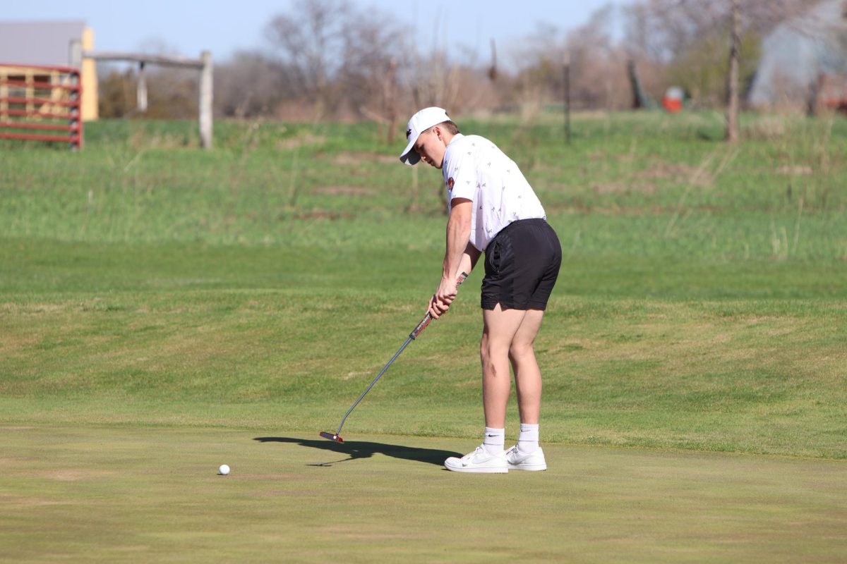 In a JV meet vs Benton, Gage Weber (11) putts on hole 17 at Pin Oak. Weber went out for golf for the first time this year.