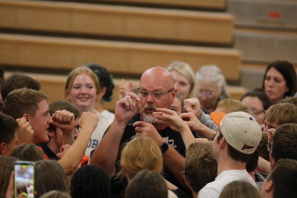 At the 2023 homecoming assembly, Doug Winkowitsch closes it out leading the entire school in an EV chant.