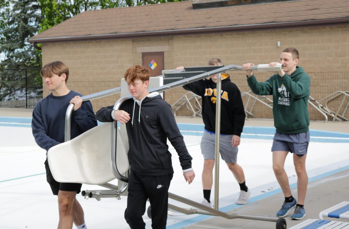 At the Manchester Aquatic Center, seniors Ethan Grawe, Brayden Maury, Brody Kafer, and Zach Wenger help to get the pool summer-ready.