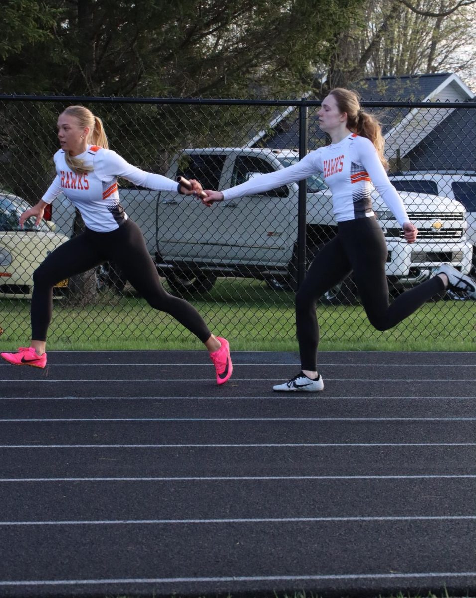 Nora Peyton (10) and Addison Huffman (11) run in the sprint medley and finish in second place. 
