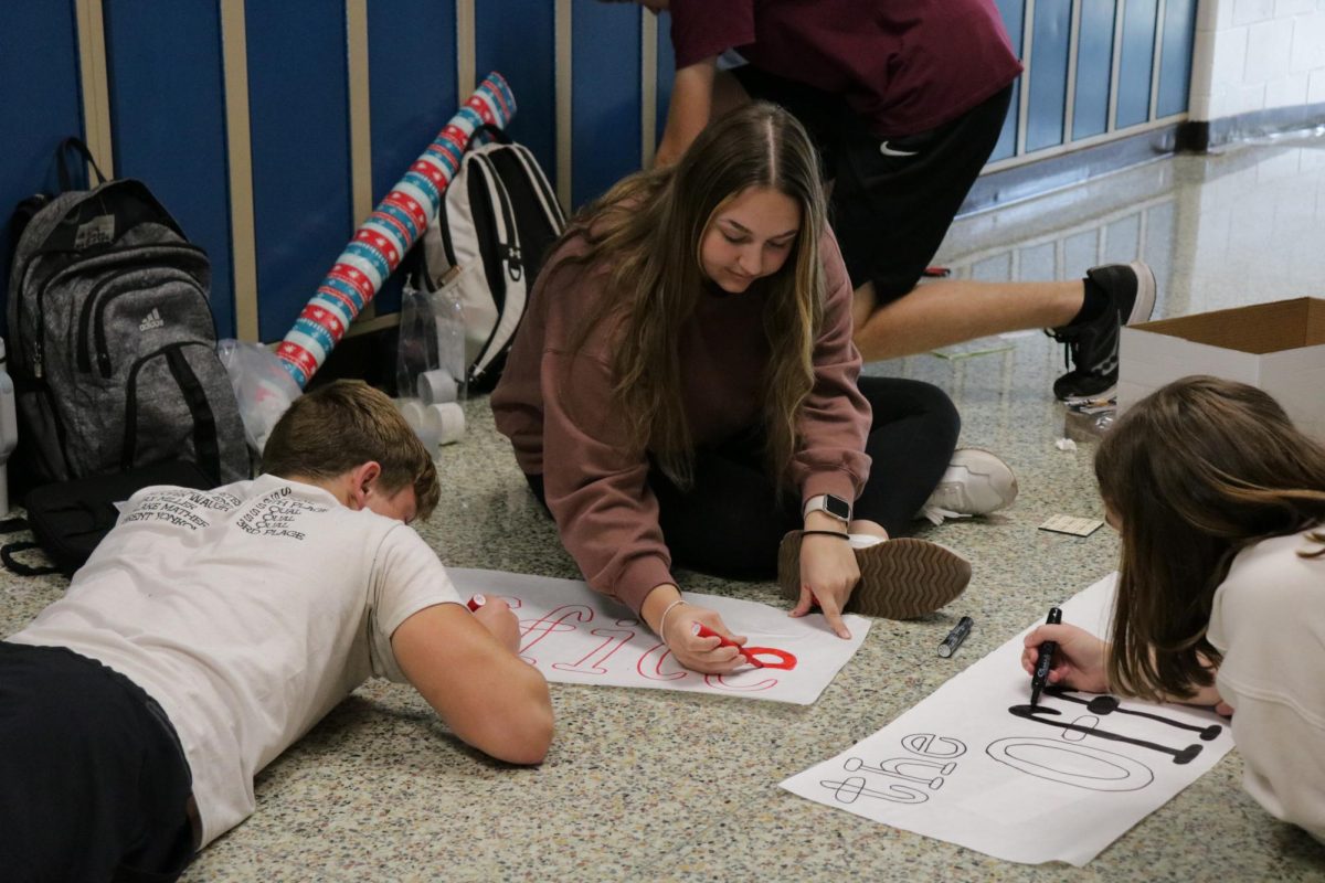 After school on Friday, Sept. 27, sophomores Wyatt Johnson, Katie Kass, and Avery Carroll made signs to decorate the hallway during homecoming week. The sophomore's hallway theme was "The Office." 