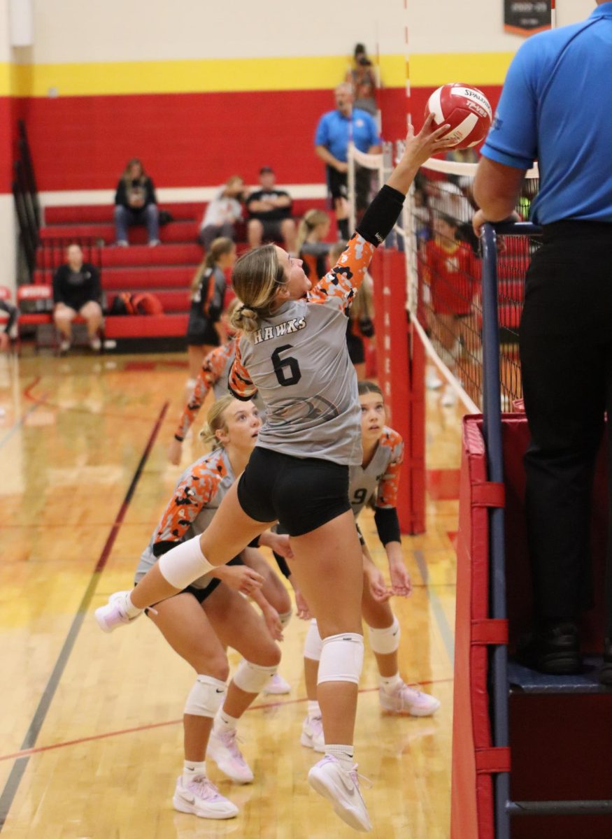 During the junior varsity game against Marion on Tuesday, junior Maleigha Hildebrand tips the ball. The JV Hawks won, 21-16 and 21-19.