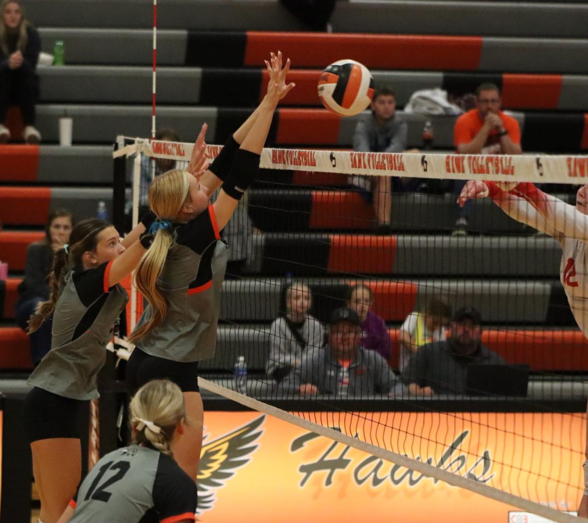 On Thursday, juniors Emma Schmidt and Lauren LeClere strive to block the ball. LeClere led West Delaware with seven blocks. 