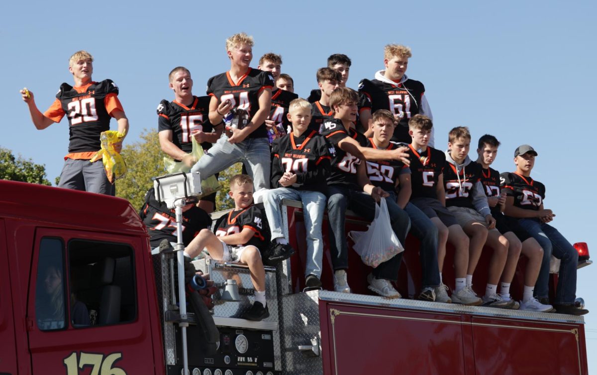 During the homecoming parade, junior boys throw out candy. 