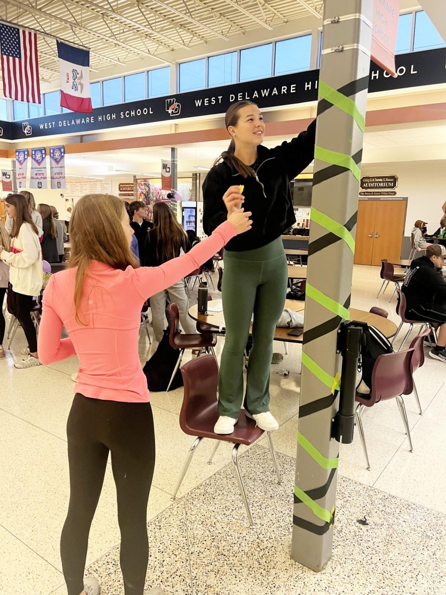 On Monday, Oct. 29, freshmen Abbigail Stoffel and Kaci Reth help decorate the commons for Halloween.