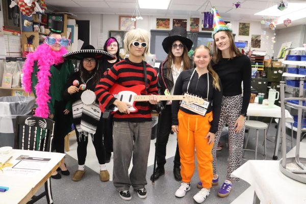 Gathering for a picture, teacher Pitzenberger-Timp's art class show off their costumes.