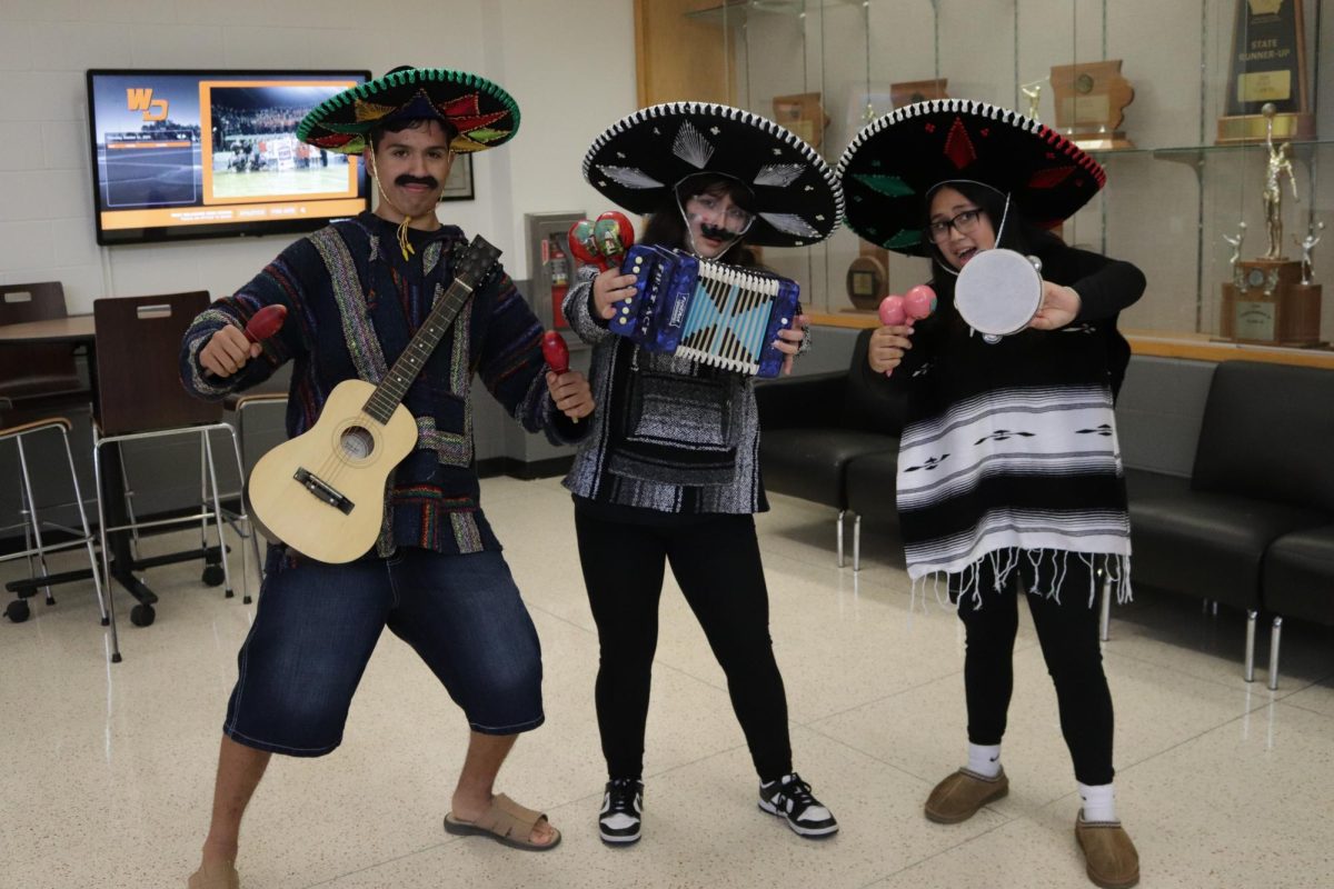 Reconized as the "Best Dressed Group," Jaxson Garcia (9), Monika Hernandez (12), and Mia Cuevas (12) proudly pose with their instruments.