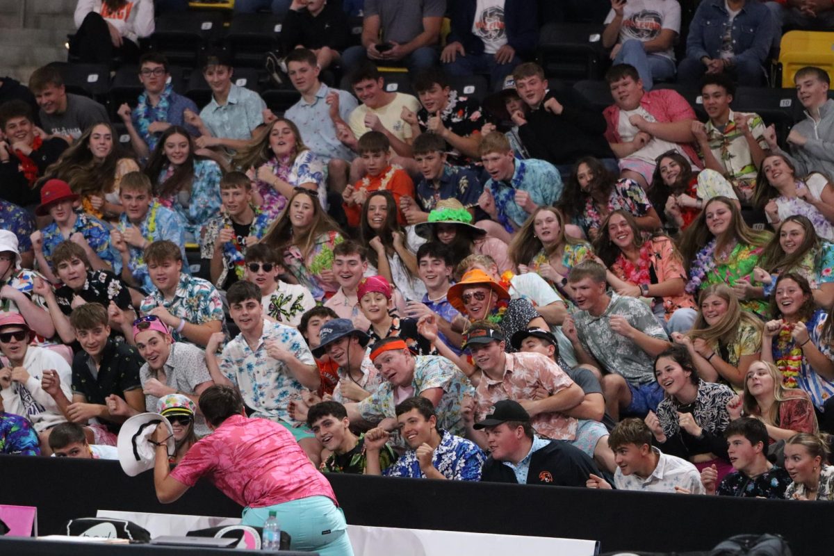 Supporting West Delaware at the state quarterfinals, Griffin Lott (12) leads the student section with the rollercoaster to energize the audience.