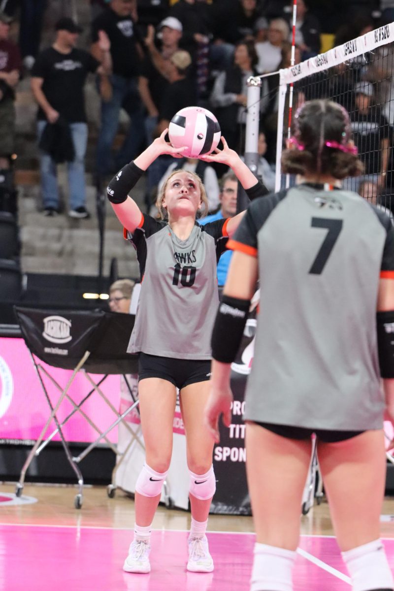 Warming up for an intense game, Natalie Mensen (11) and Kirstyn Kolbet (12) set to each other.