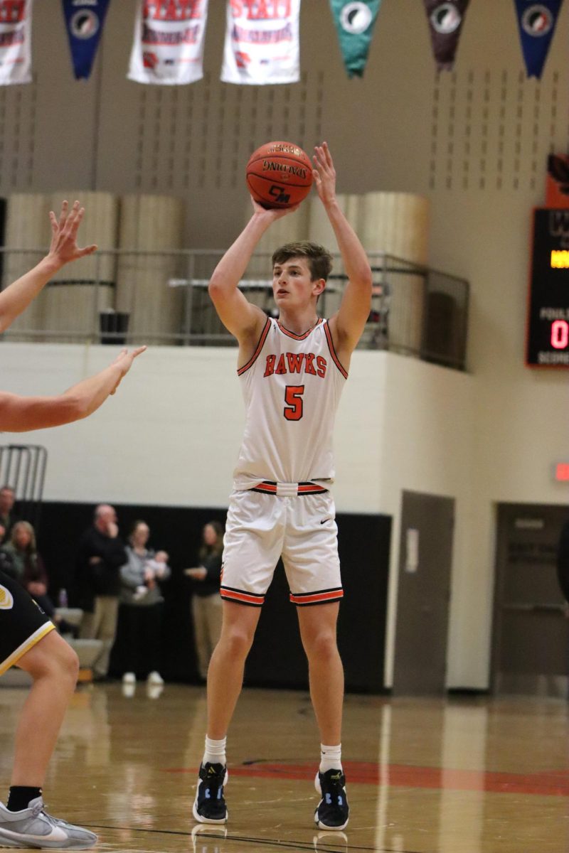 After a foul, Keagan Jackson (12) shoots a free throw during the game against Maquoketa Valley on Nov. 22. The boys varsity went 80% on free throws. 