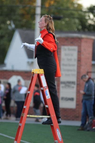 Claire Manson directs the marching band during one of Friday night's football games. 