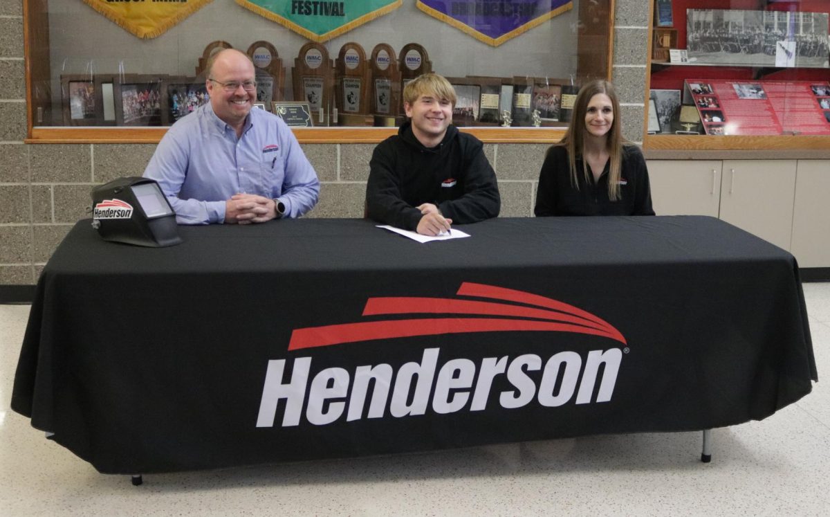 Junior Aiden Wulfekuhle signs his letter of intent with Henderson Products. With Wulfekuhle is Thomas Kenny, left, welding engineer at Henderson Products, and Holly Stiefel, right, Henderson Products human resources manager. 