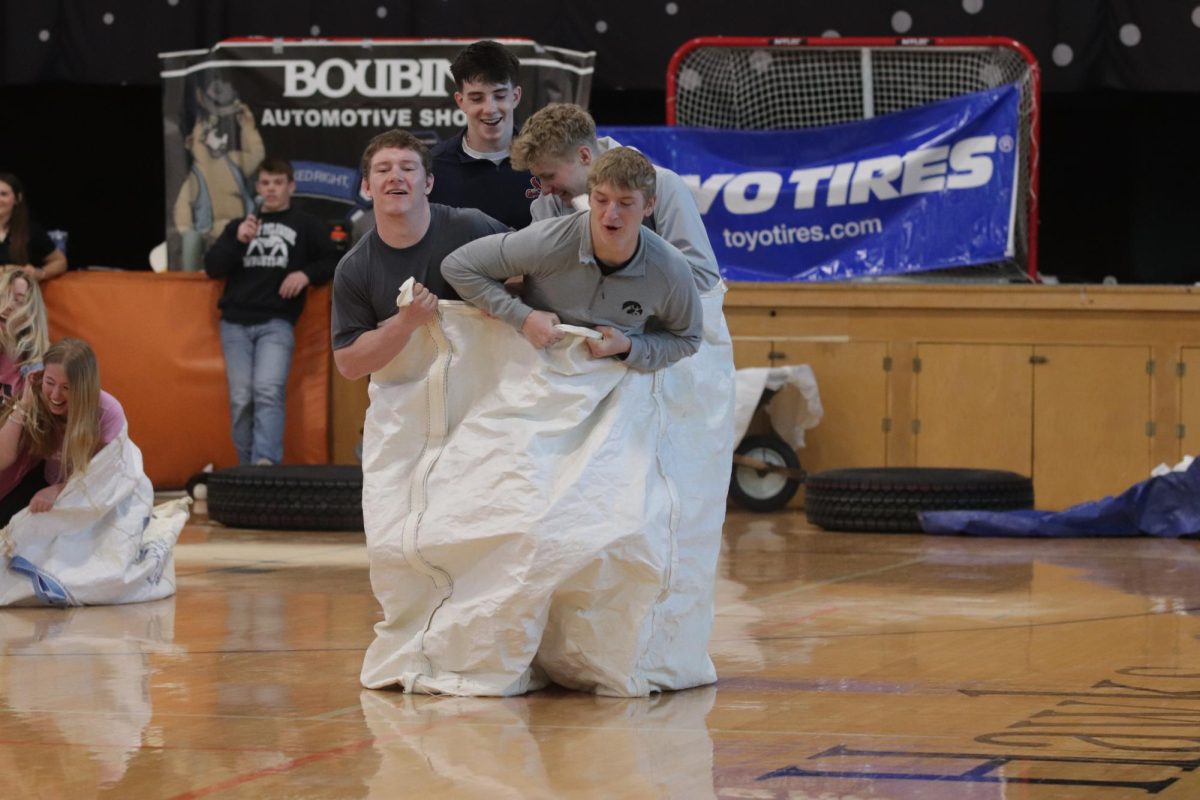 During the Ag Olympics Assembly, juniors Blake Mather, Jack Cantwell, Austin Schneiders, and Macoy Roling compete  in the potato sack race.