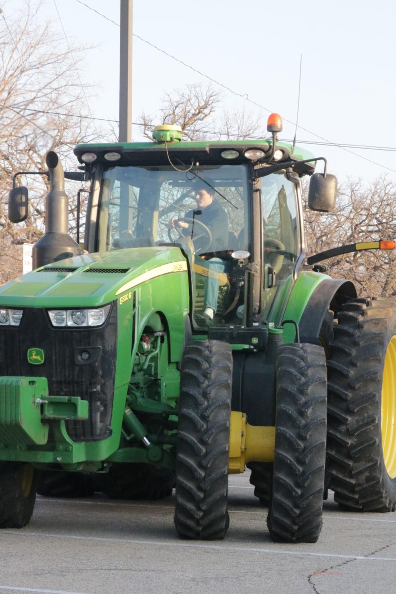 Paul Beswick (10) drives his John Deere 8320 into the school lot. "It's fun driving a tractor around town," Beswick said.